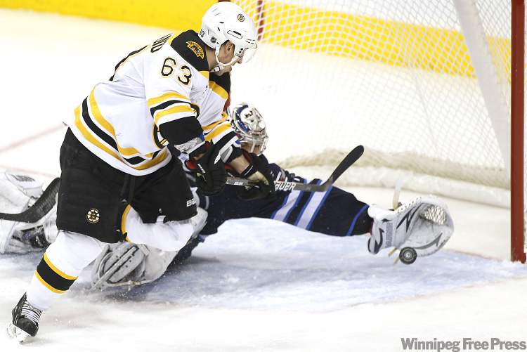 John Woods / Winnipeg Free Press
Winnipeg Jets' goaltender Ondrej Pavelec (31) gets his glove on Boston Bruins' forward Brad Marchand's (63) shot during second-period NHL action in Winnipeg on Tuesday.