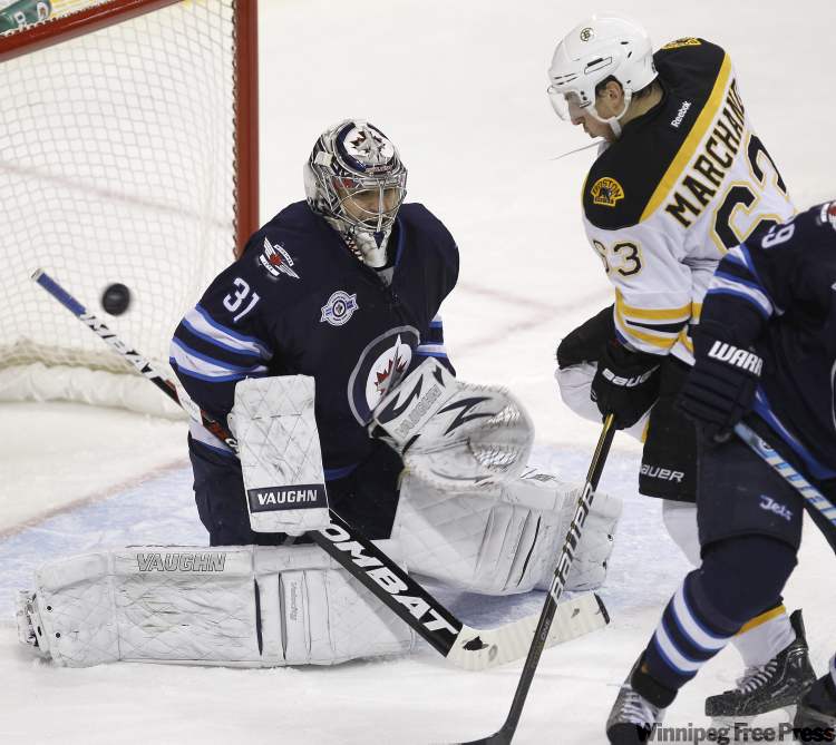 Trevor Hagan/ The Canadian Press
Winnipeg Jets' goaltender Ondrej Pavelec (31) is screened by Boston Bruins' Brad Marchand and Winnipeg Jets' Johnny Oduya (29) during second-period NHL action in Winnipeg Tuesday.