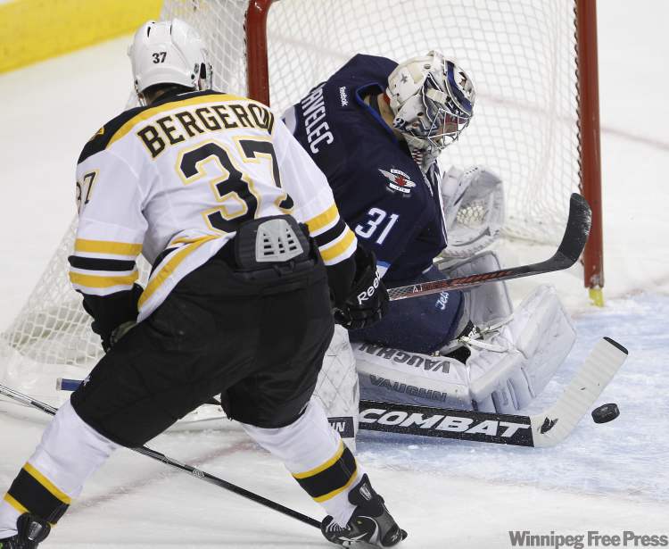 Trevor Hagan / The Canadian Press
Winnipeg Jets' goaltender Ondrej Pavelec (31) makes a paddle save with Boston Bruins' Patrice Bergeron on the doorstep during second-period NHL action in Winnipeg Tuesday.
