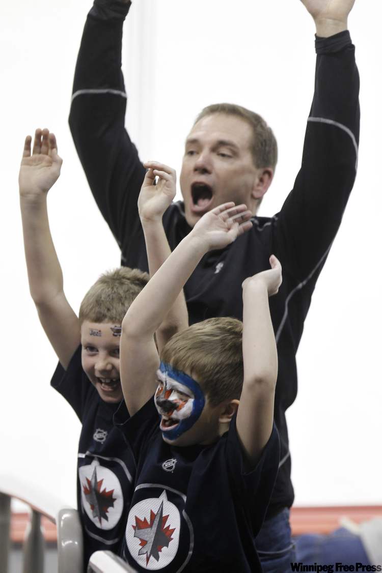 Trevor hagan / The Canadian Press
Young Winnipeg Jets' fans start the wave as the Jets beat the Boston Bruins during third-period NHL action in Winnipeg Tuesday.
