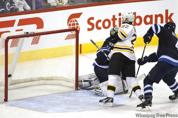 John Woods / Winnipeg Free Press
Winnipeg Jets' goaltender Ondrej Pavelec (31) and defenceman Zach Bogosian (4) can't stop Boston Bruins' forward Shawn Thornton (22) from scoring during third-period NHL action in Winnipeg on Tuesday.