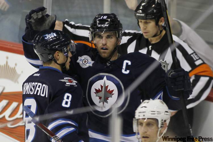John Woods / Winnipeg Free Press
Winnipeg Jets' forward Andrew Ladd (16) and forward Alexander Burmistrov (8) celebrate Ladd's goal against the Boston Bruins' during first-period NHL action in Winnipeg on Tuesday.