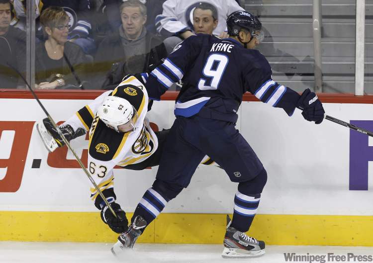 Trevor Hagan / The Canadian Press
Winnipeg Jets' Evander Kane (9) collides with Boston Bruins' Brad Marchand during first-period NHL action in Winnipeg Tuesday.