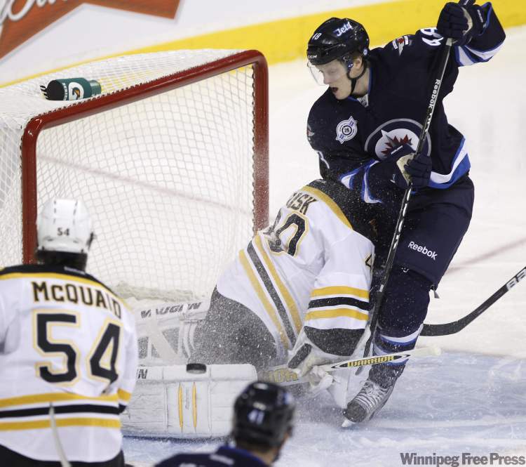 Trevor Hagan / The Canadian Press
Winnipeg Jets' Carl Klingsburg (48) crashes into Boston Bruins' goaltender Tuukka Rask (40) during first period NHL action in Winnipeg Tuesday.