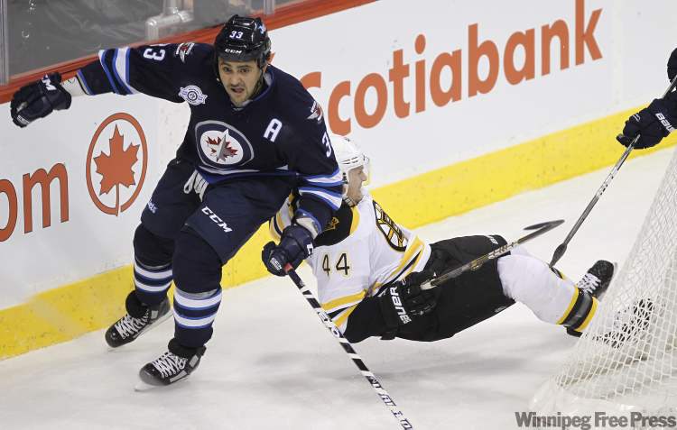 Trevor Hagan / The Canadian Press
Winnipeg Jets' Dustin Byfuglien (33) bumps Boston Bruins' Dennis Seidenberg behind the Bruins net during first-period NHL action in Winnipeg Tuesday.