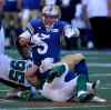 TREVOR HAGAN / THE CANADIAN PRESS
Saskatchewan Roughriders defenders Ricky Foley (95) and Chad Kilgore tackle Winnipeg Blue Bombers quarterback Drew Willy during the first half of the Banjo Bowl at Investors Group Field Sunday. The Riders won 30-24.