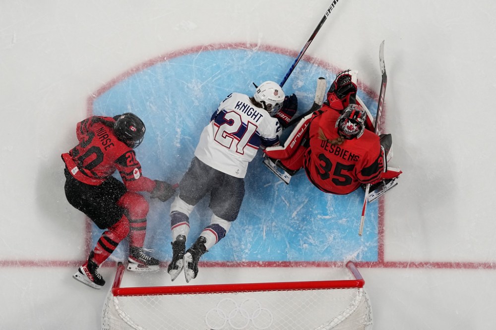CP
United States' Hilary Knight (21) slides into Canada goalkeeper Ann-Renee Desbiens (35) during the women's gold medal hockey game at the 2022 Winter Olympics, Thursday, Feb. 17, 2022, in Beijing. At left is Canada's Sarah Nurse (20). (Petr David Josek / The Associated Press)