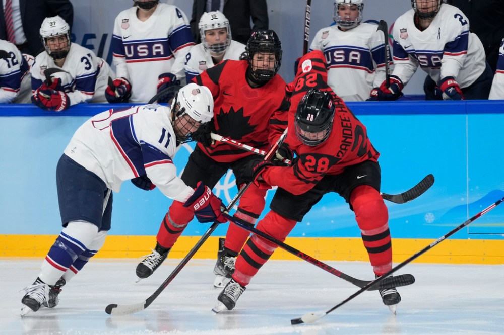 CP
Canada's Micah Zandee-Hart (28) and United States' Abby Roque (11) go for the puck during the women's gold medal hockey game at the 2022 Winter Olympics, Thursday, Feb. 17, 2022, in Beijing. (Petr David Josek / The Associated Press)