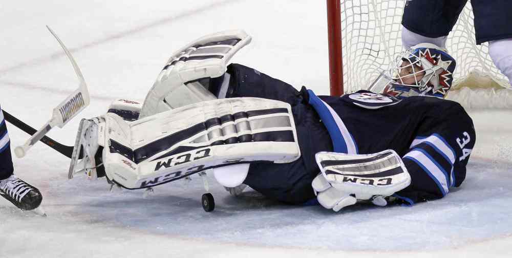 Phil Hossack / Winnipeg Free Press
Winnipeg Jets net-minder Michael Hutchinson covers up against a second-period St. Louis Blues power play.