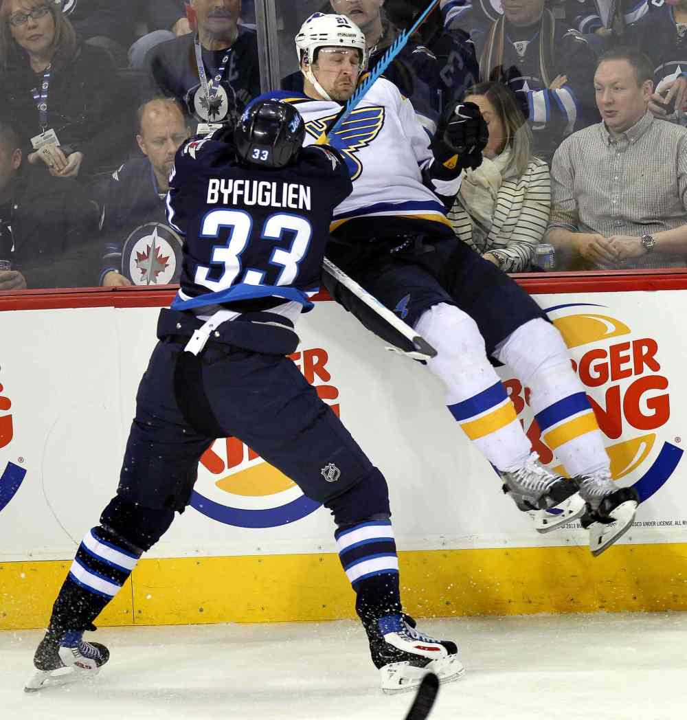 Phil Hossack / Winnipeg Free Press
Winnipeg Jets Dustin Byfuglien puts St. Louis Blues Patrik Berglund deep in the St. Louis zone during the second period of Thursday's game.