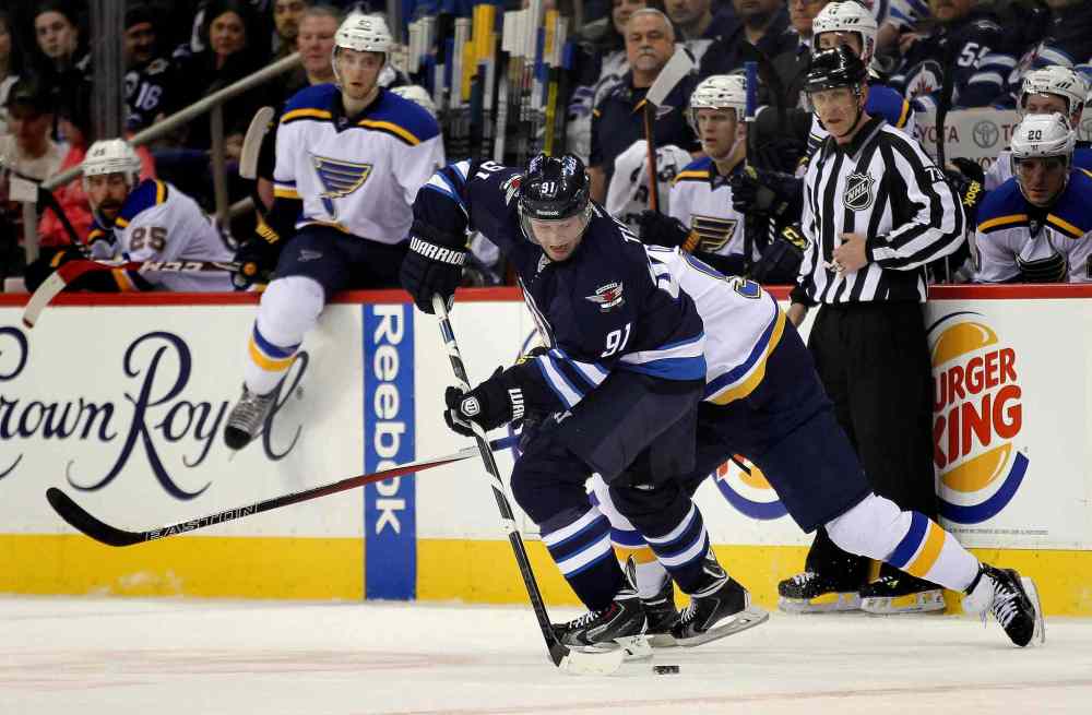 Phil Hossack / Winnipeg Free Press
Winnipeg Jets newcomer Jiri Tlusty takes possession of the puck in front of the Blues bench in the first period of Thursday's game.