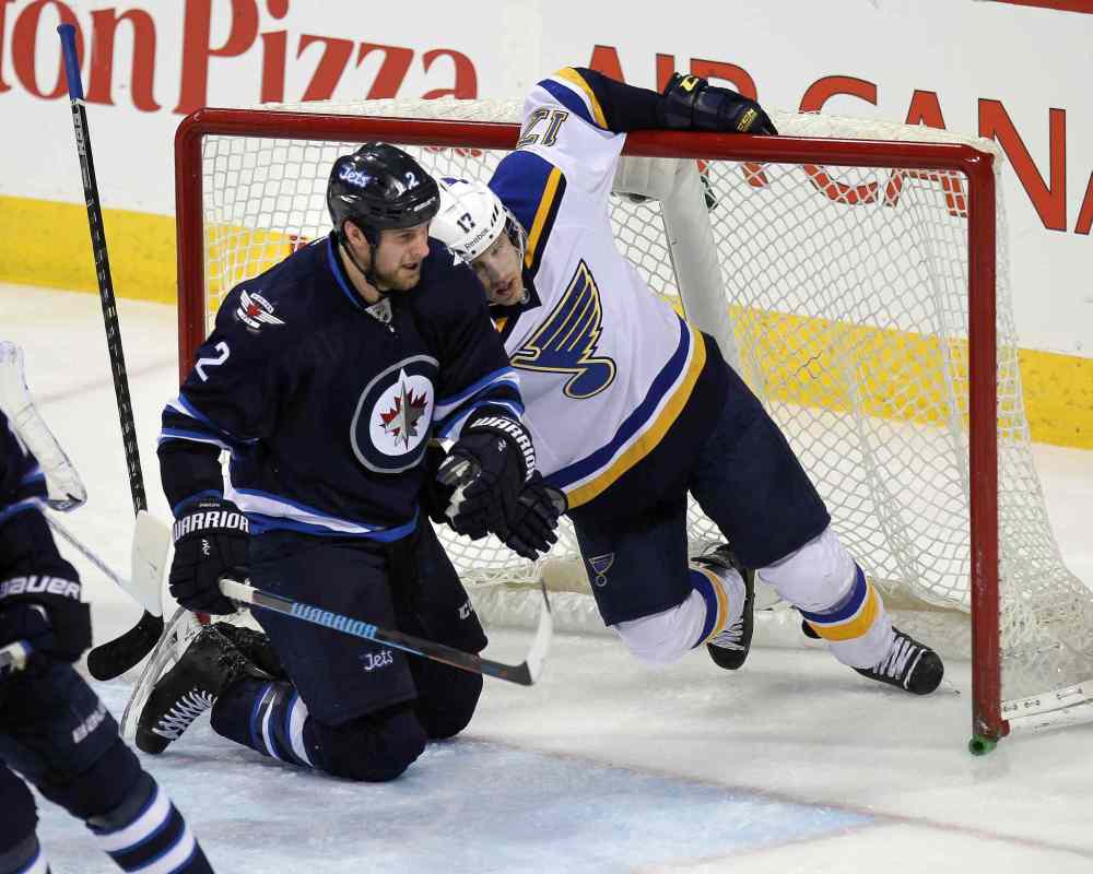 Phil Hossack / Winnipeg Free Press
Winnipeg Jets Adam Pardy and St. Louis Blues #17Jaden Schwatz get tangled up in the web of Jets goalie Michael Hutchinson during second period Thursday.