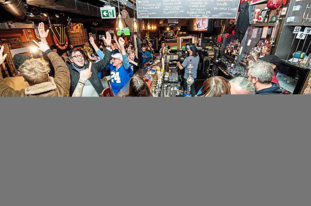 Hugs and cheers all around at the King's Head Pub. (Mike Sudoma / Winnipeg Free Press)