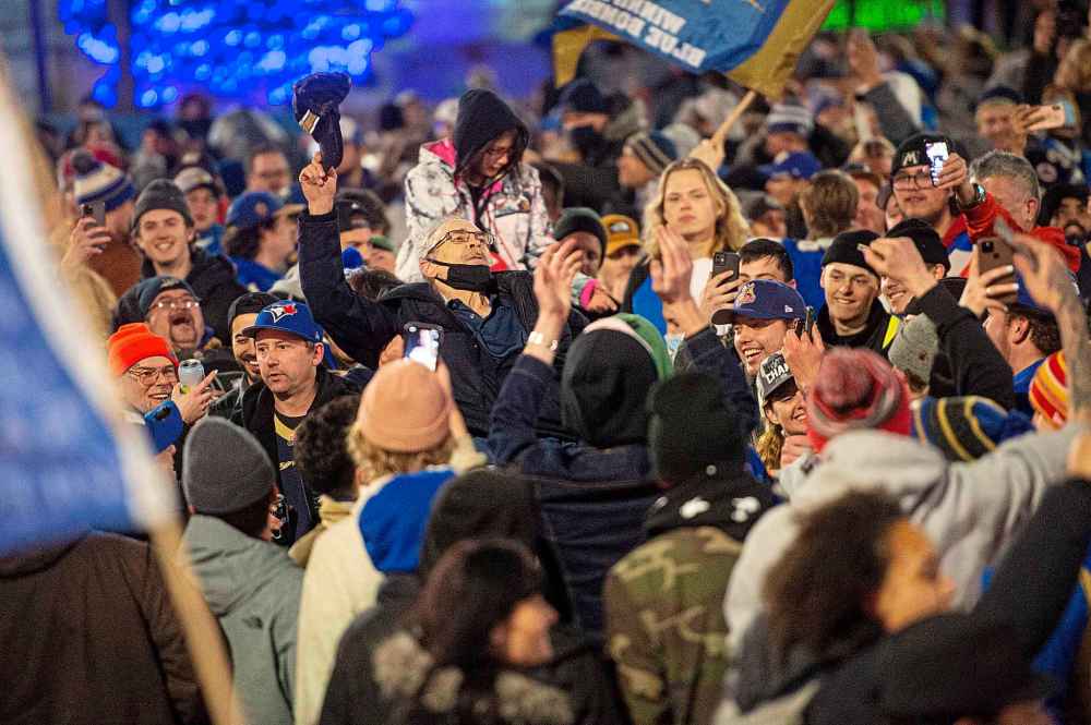 A Bomber fan crowd surfs atop hundreds of fans. (Mike Sudoma / Winnipeg Free Press)