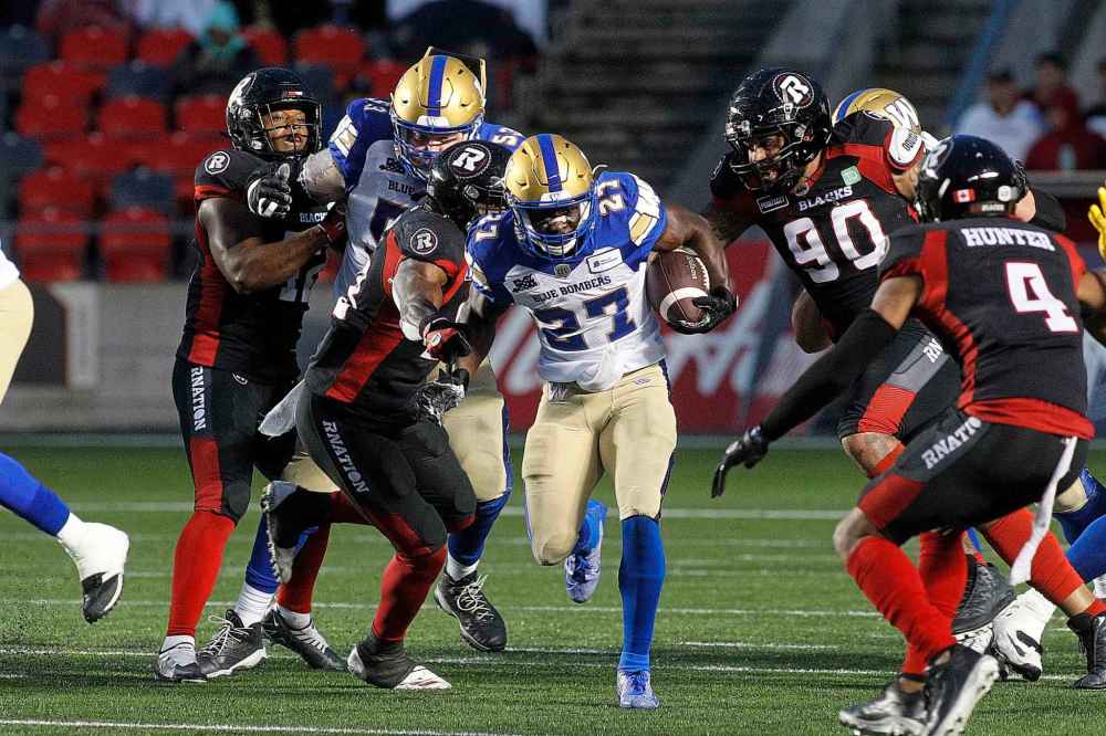 THE CANADIAN PRESS
Winnipeg Blue Bombers running back Johnny Augustine runs against the Ottawa Redblacks during the first half. (Lars Hagberg / The Canadian Press files)