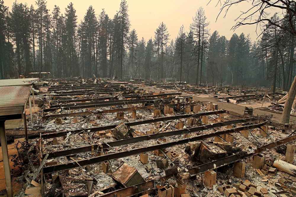 Charred remains of mobile homes line a street at a mobile home park burned in Paradise, Calif. (John Locher / The Associated Press)