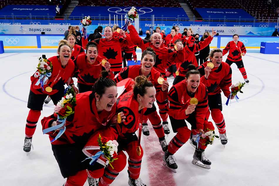 Canada players celebrate with their gold medals after the women's gold medal hockey game at the 2022 Winter Olympics, Thursday, Feb. 17, 2022, in Beijing. (Matt Slocum / The Associated Press)