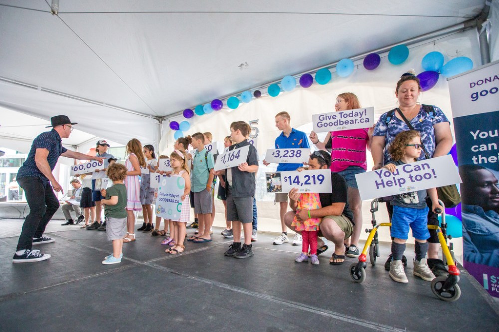 DANIEL CRUMP / WINNIPEG FREE PRESS
Kids hold up signs with amounts that they have helped fundraise for the Better Futures program during a Children’s Hospital Foundation of Manitoba event at True North Square.