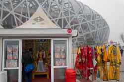 Ng Han Guan / The Associated Press
Tourists dressed in traditional imperial costumes poses for photos in a booth near the iconic Bird