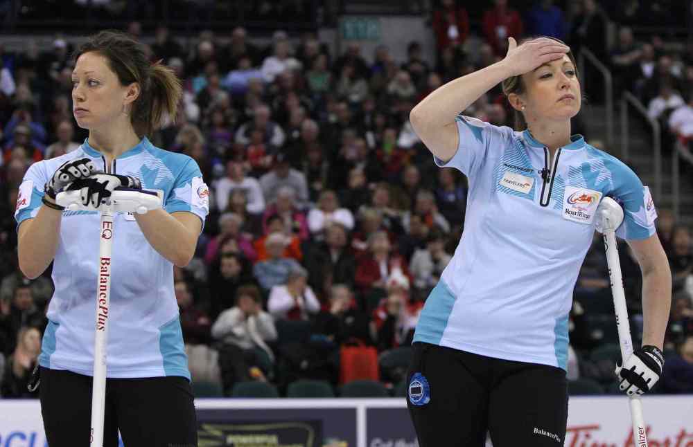 Jason Halstead / Winnipeg Free Press
Sherry Middaugh's second Lee Merklinger (left) and lead Leigh Armstrong react to a shot.
