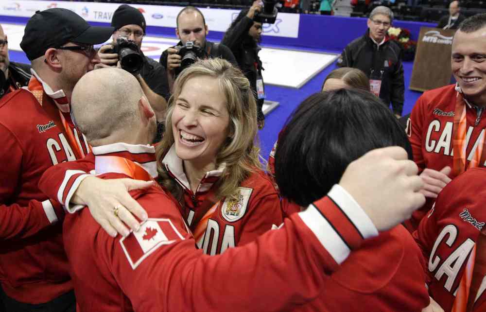 Jason Halstead / Winnipeg Free Press
Skip Jennifer Jones (centre) and Ryan Fry hug after the men's team was presented with their Team Canada jackets and Roar of the Rings medals.