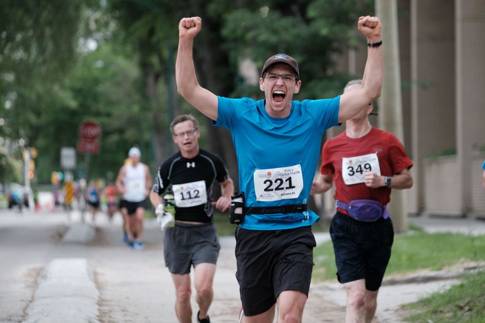 DANIEL CRUMP / WINNIPEG FREE PRESS
Nicholas Pasieczka, 17, pumps his hands in the air during a milestone adventure in his life. He went on to finish first place in the youth male category in the full marathon.
