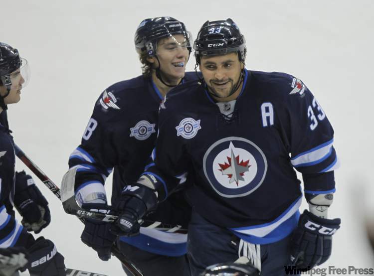 Boris Minkevich / Winnipeg Free Press
Winnipeg Jets' Dustin Byfuglien (33) celebrates his first-period goal which made the score 2-0 for the Jets.