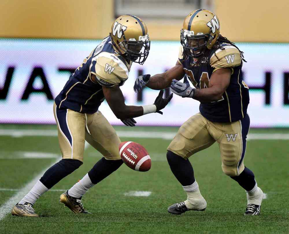 Phil Hossack / Winnipeg Free Press
Winnipeg Blue Bombers' running back Nic Grigsby, left, and #34 Paris Cotton bobble a kick from the Edmonton Eskimos deep in the Bombers' zone during Thursday's game.