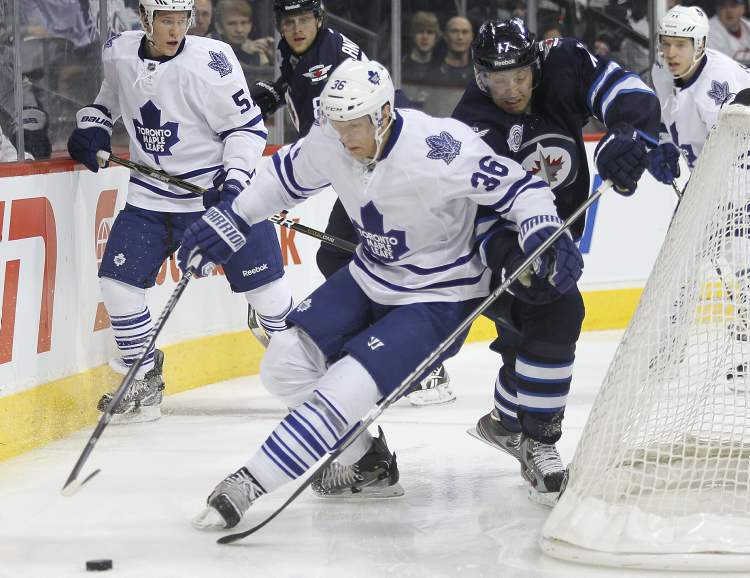 John Woods / Winnipeg Free Press
Winnipeg Jets' Eric Fehr and Toronto Maple Leafs' Carl Gunnarsson jostle for the puck behind the Leafs' net during second-period NHL action Tuesday.