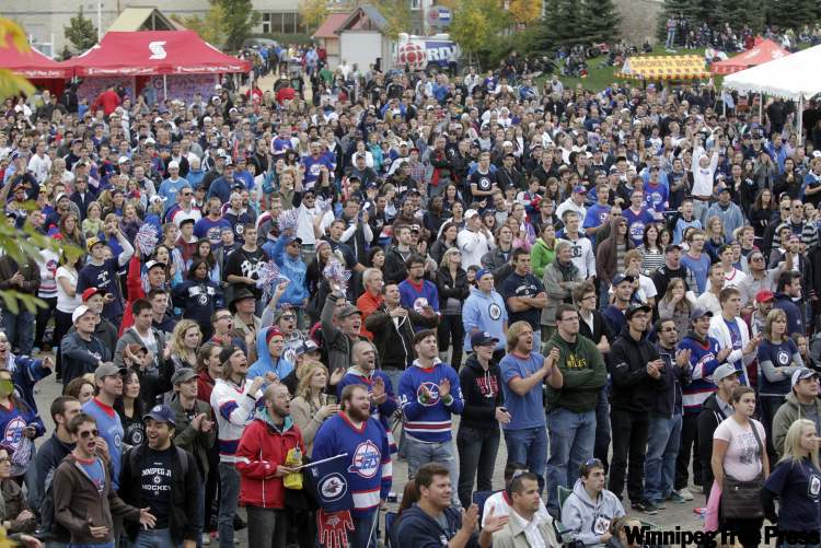 A large crowd watches the Winnipeg Jets season-opener against the Montreal Canadiens on large screens at The Forks Sunday. (Wayne Glowacki / Winnipeg Free Press)