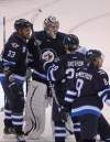 Happy Winnipeg Jets  congratulate goaltender Ondrej Pavelec after the  victory. (Boris Minkevich / Winnipeg Free Press)