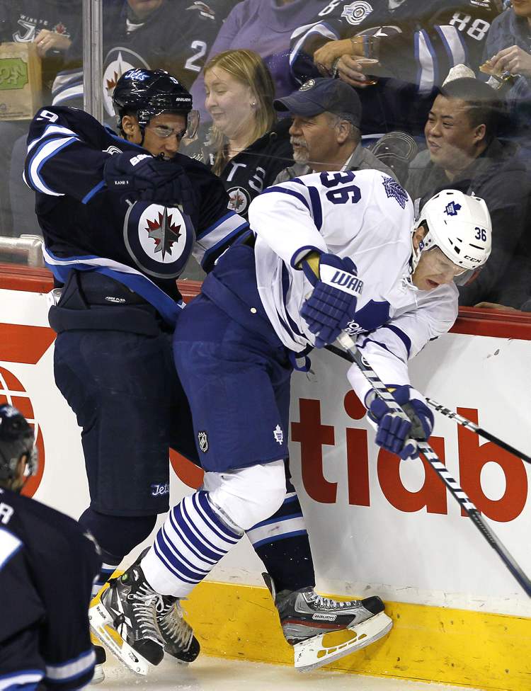 John Woods / Winnipeg Free Press
Winnipeg Jets' Evander Kane and Toronto Maple Leafs' Carl Gunnarsson (36) go in hard against the boards during first-period actionat the MTS Centre Tuesday.