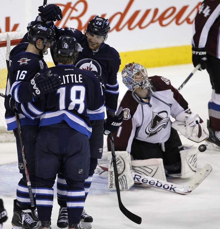Trevor Hagan / The Canadian Press
Winnipeg Jets' Andrew Ladd (16), Bryan Little (18), and Blake Wheeler (26) celebrate a goal by Little after he put the puck past Colorado Avalanche's goaltender Semyon Varlamov during third period.