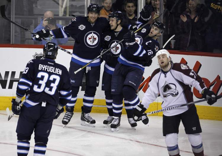 Trevor Hagan / The Canadian Press
Winnipeg Jets' Dustin Byfuglien (33), Blake Wheeler (26), Bryan Little (18) and Andrew Ladd (16) celebrate a goal by Wheeler against the Colorado Avalanche during the second period