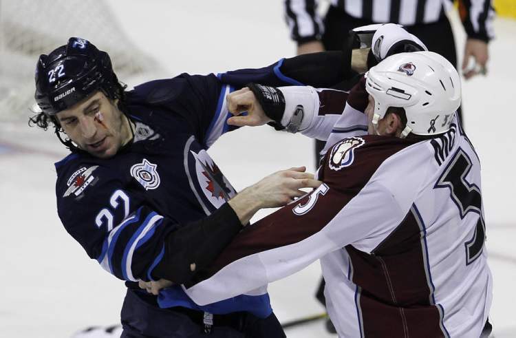 Trevor Hagan / The Canadian Press
Winnipeg Jets' Chris Thorburn (22), drops the gloves with Colorado Avalanche's Cody McLeod (55).