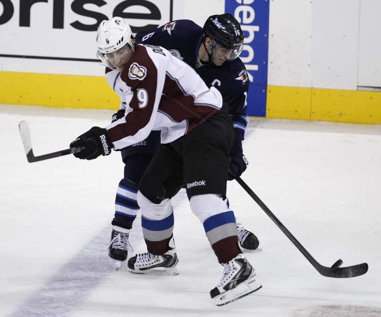 Trevor Hagan / The Canadian Press
Colorado Avalanche's Matt Duchene (9) puts a hard check into Winnipeg Jets' Andrew Ladd (16).
