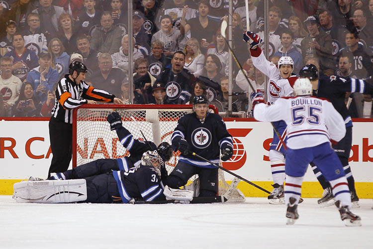 John Woods / The Canadian Press
Montreal Canadiens' Lars Eller (81) and Francis Bouillon (55) celebrate a goal against the Winnipeg Jets during the second period,