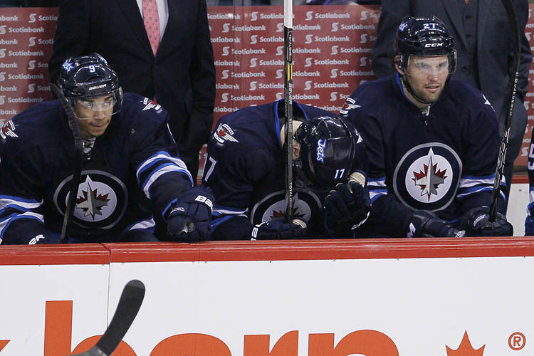 JOHN WOODS / The Canadian Press
Winnipeg Jets' James Wright (17), Evander Kane (9) and Eric Tangradi (27) shows their disappointment during the third period.