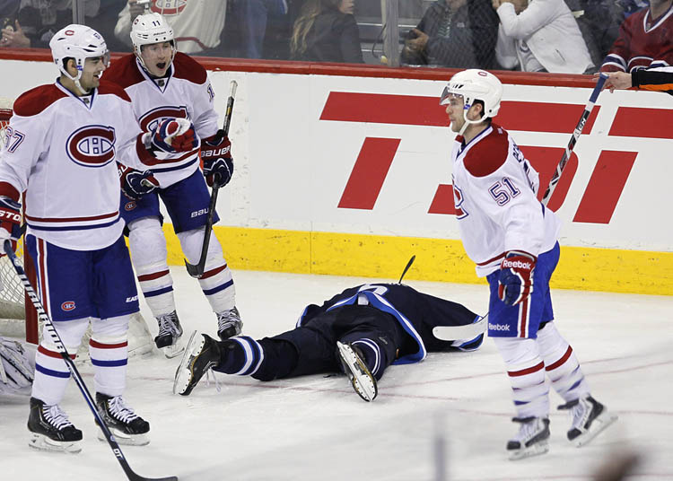 JOhn woods / The Canadian Press
Montreal Canadiens' David Desharnais (51) celebrates his goal on the Winnipeg Jets with Max Pacioretty (67) and Brendan Gallagher as Jets' Mark Stuart lies on the ice during third period.