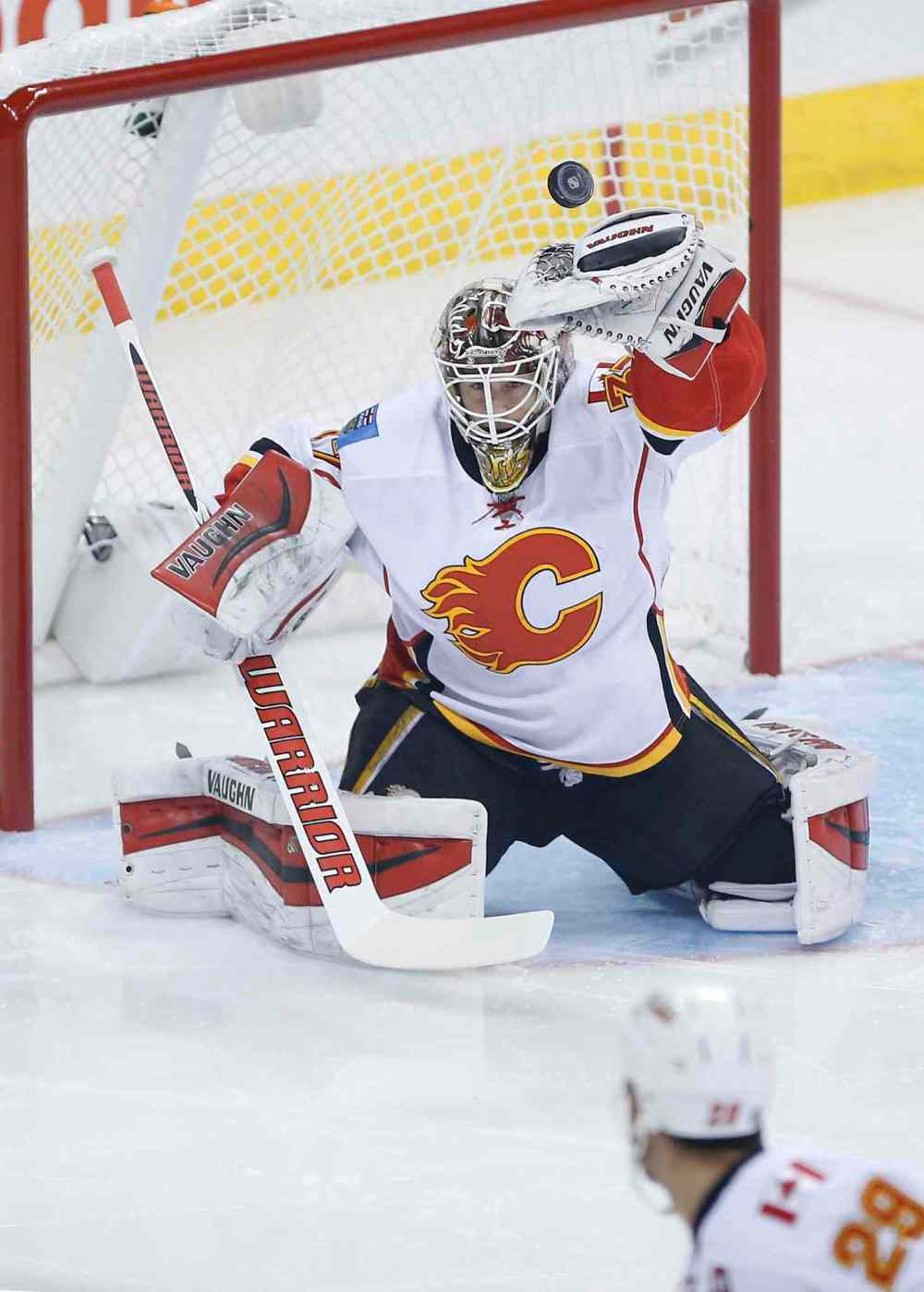 John Woods / The Canadian Press
Winnipeg Jets' Drew Stafford's (not shown) shot from the point goes over the glove of Calgary Flames goaltender Joni Ortio (37) as Flames' Deryk Engelland (29) looks on during first period NHL action on Saturday. T