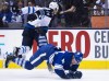 Nathan Denette / The Canadian Press
Toronto Maple Leafs defenceman Morgan Rielly, right, gets taken down by Winnipeg Jets forward Anthony Peluso, left, during first period NHL hockey action in Toronto on Saturday.