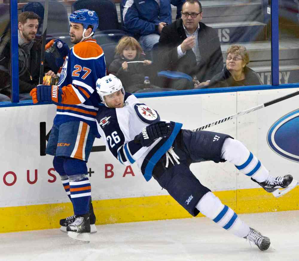 Jason Franson / The Canadian Press
Winnipeg Jets' Blake Wheeler (26) trips over Edmonton Oilers' Boyd Gordon (27) during the second period in Edmonton Monday.