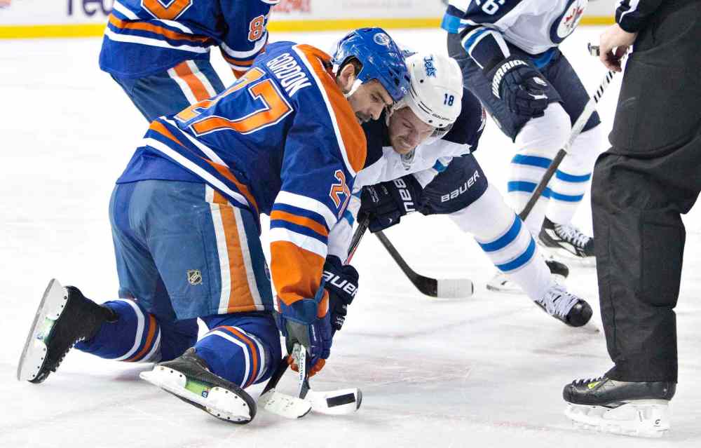 Jason Franson / The Canadian Press
Winnipeg Jets' Bryan Little (18) and Edmonton Oilers' Boyd Gordon (27) battle in the face-off circle during first period NHL hockey action in Edmonton, Alta., on Monday.