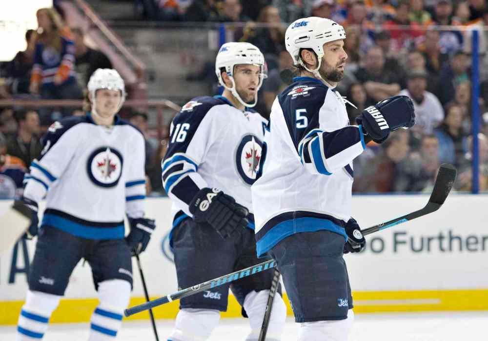 Jason Franson / The Canadian Press
Winnipeg Jets' Jacob Trouba (8), Andrew Ladd (16) and Mark Stuart (5) celebrate a goal against the Edmonton Oilers during first period NHL hockey action in Edmonton, Alta., on Monday.