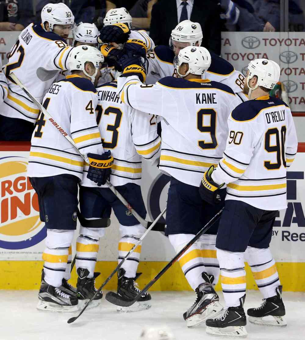 CP
The Buffalo Sabres' bench congratulates Sam Reinhart (23) after he completes a hat trick against the Winnipeg Jets' during third period NHL hockey action in Winnipeg, Sunday, January 10, 2016. THE CANADIAN PRESS/Trevor Hagan