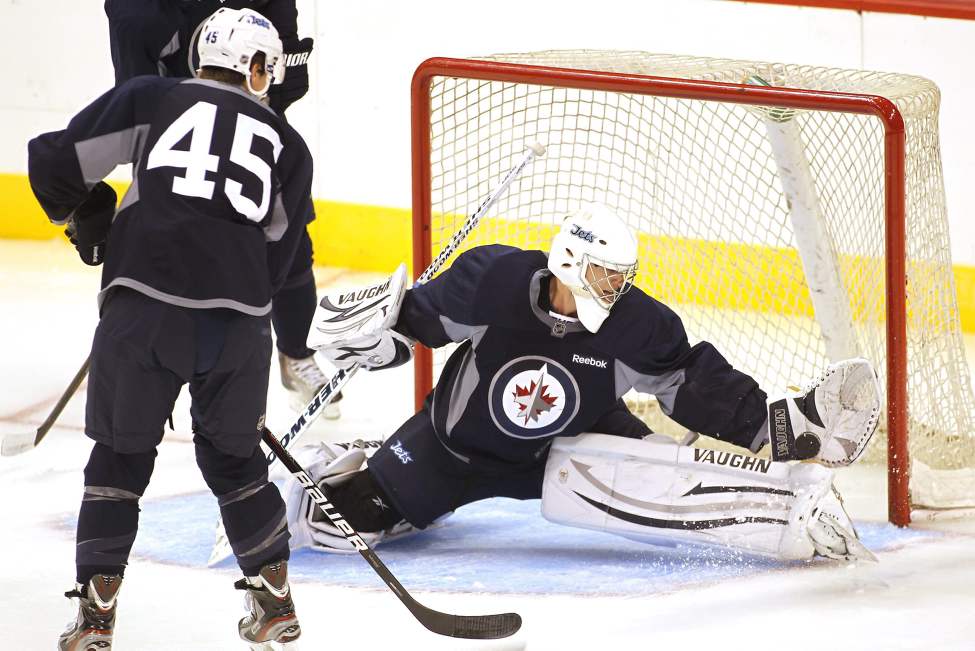 John Woods / The Canadian Press
Winnipeg Jets goalie Chris Carrozzi (35) stops a shot from Mark Scheifele (45) on day two of the 2011 training camp in Winnipeg Sunday.
