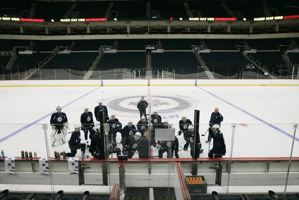 John Woods / The Canadian Press
Winnipeg Jets players listen to head coach Claude Noel on Sunday.
