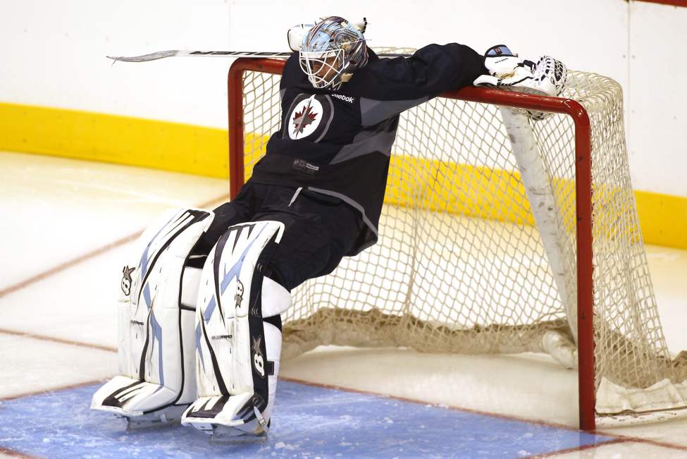 John Woods / The Canadian Press
Chris Mason (50) stretches Sunday.