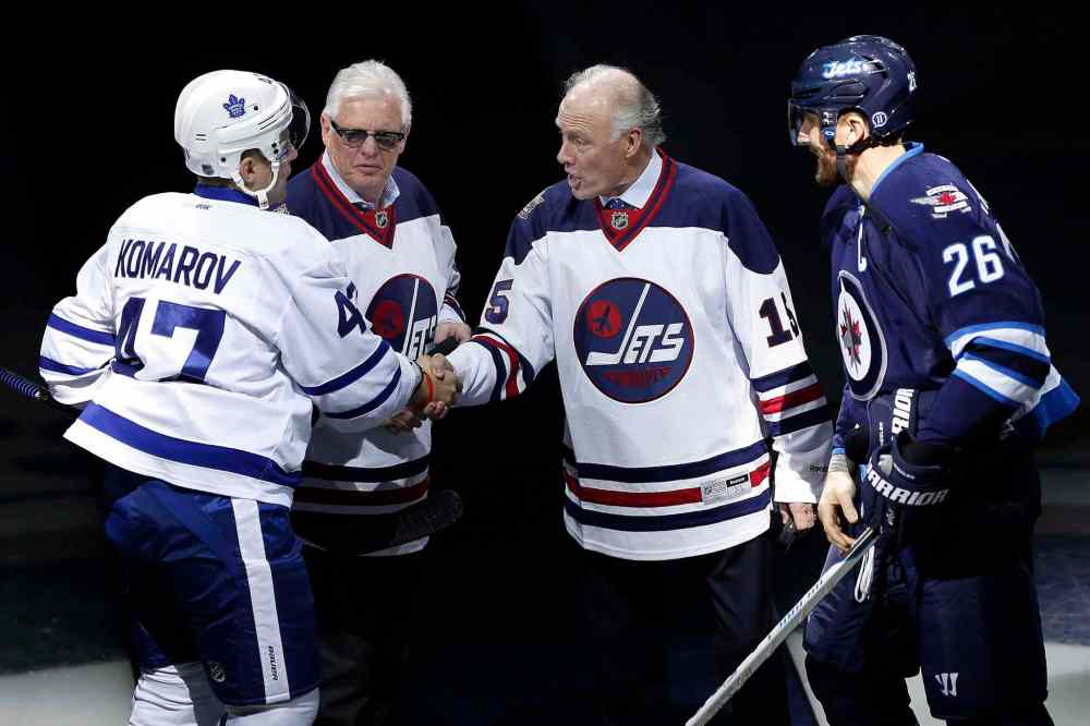 JOHN WOODS / THE CANADIAN PRESS
Former Winnipeg Jets' Anders Hedberg (R) shakes hands with Toronto Maple Leafs' Leo Komarov (47) as Ulf Nilsson and Winnipeg Jets' Blake Wheeler (26) look on during induction ceremony into the Winnipeg Jets Hall of Fame in Winnipeg on Wednesday, October 19, 2016. Bobby Hull was also inducted but did not attend.
