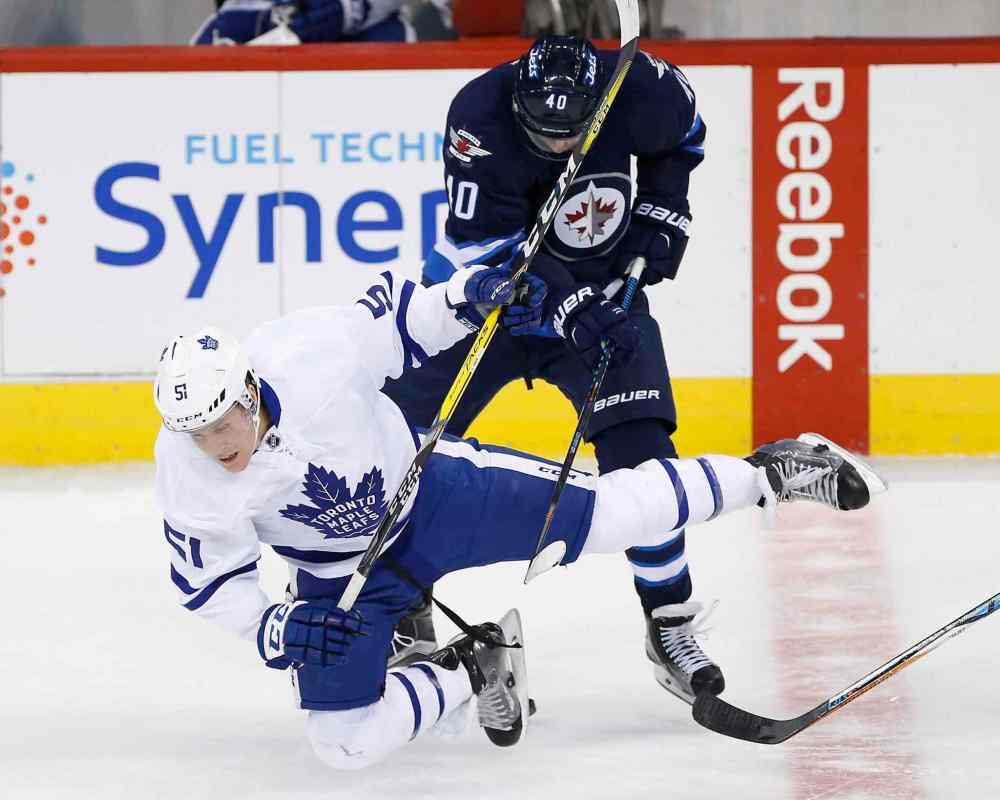 JOHN WOODS / THE CANADIAN PRESS
Winnipeg Jets' Joel Armia (40) checks Toronto Maple Leafs' Jake Gardiner (51) during first period NHL action in Winnipeg on Wednesday, October 19, 2016.